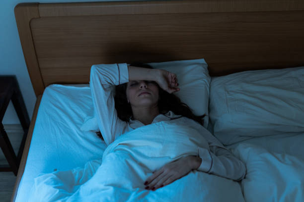 istock Sleepless young woman suffering from insomnia, covering eyes with hands 2193727116