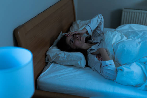 istock Sleepless young woman suffering from insomnia, covering eyes with hands 2193727661