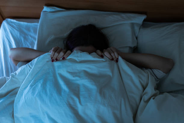 istock Sleepless young woman suffering from insomnia, covering eyes with hands 2193727699