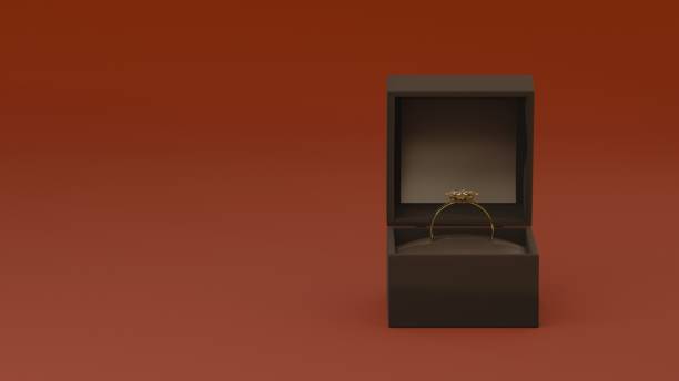 istock Elegant gold ring in black velvet box on red background 2193728705