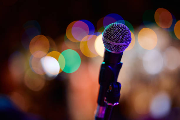 istock Focus on microphone before heavy metal concert in vibrant atmosphere 2193731639