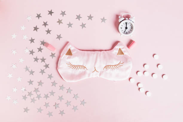 istock Concept good sleep, sleeping pills, sleep mask and stars on pink background 2193733981