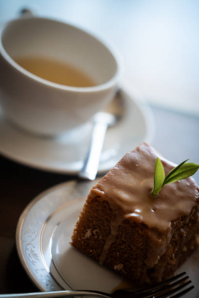 Indulging in a sweet caramel cake alongside a warm cup of tea, creating a perfect moment of relaxation