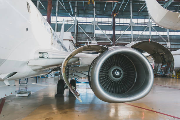 istock White passenger jet plane in the aviation hangar. Aircraft under maintenance 2193735292