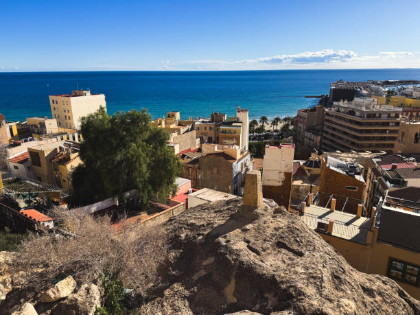 istock Coastal urban landscape with rooftops and blue ocean horizon in bright daylight 2193736873