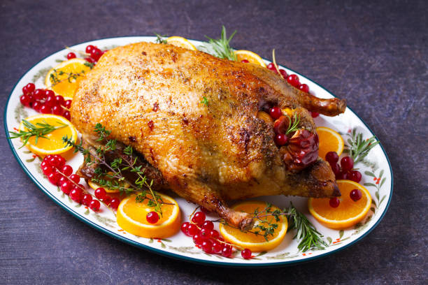 istock Roasted duck served with oranges and red currants on white plate 2193738080