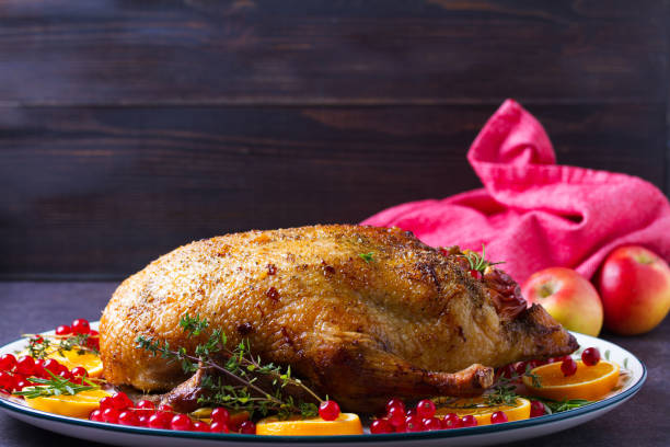 istock Roasted duck served with oranges and red currants on white plate 2193738095