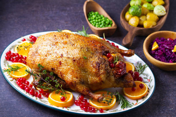 istock Roasted duck served with oranges and red currants on white plate 2193738167