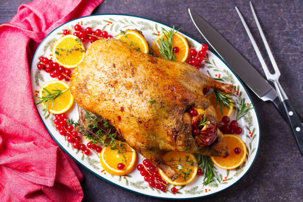 istock Roasted duck served with oranges and red currants on white plate 2193738168