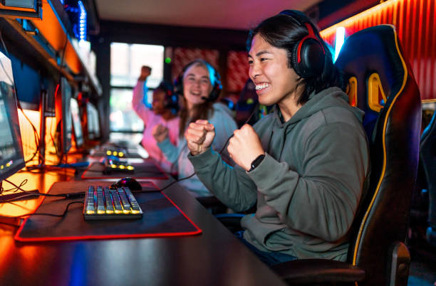 istock Young man celebrating his success after winning in video game 2193739919