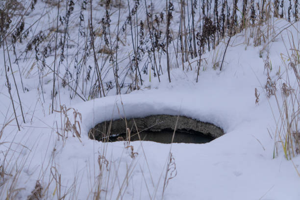 istock unsecured sewage manhole visible in the snow 2193740189
