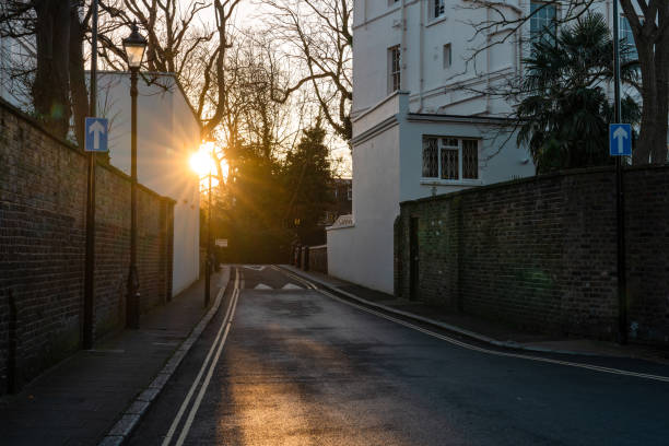 Sun shining on an empty street at sunset in a residential area of london