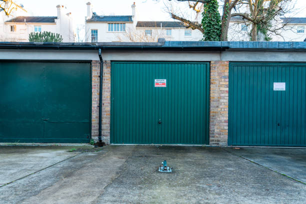 istock Three private green garage doors in a residential area 2193741555