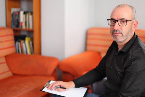 istock Mature Professional Consultant Sitting with a Notebook in a Relaxed Office Environment 2193744060