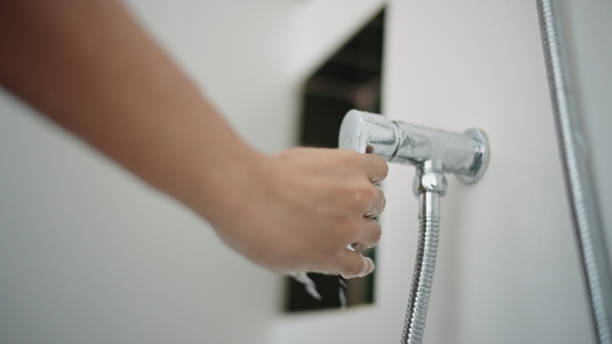 istock Close-up hand of man turning off shower. 2193744979
