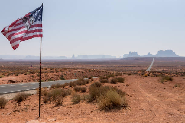 istock American Flag Waving with Monument Valley Rock Formations in the Background 2193746024