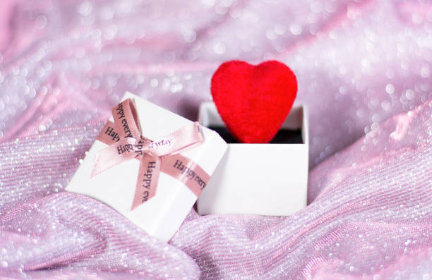 Valentine's Day Concept, Red Heart in Gift Box on Glitter Background. High quality photo