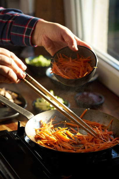 istock Preparing Bibimbap Korean Rice Dish in Domestic Kitchen 2193747926