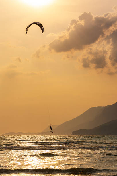 istock A woman kitesurfing alone at sunset. 2193748158