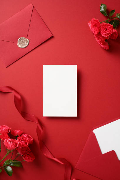 istock Romantic flat lay composition with blank white card, red envelopes, wax seal, ribbon, and roses. Perfect for Valentine's Day, weddings, or romantic invitations 2193750376