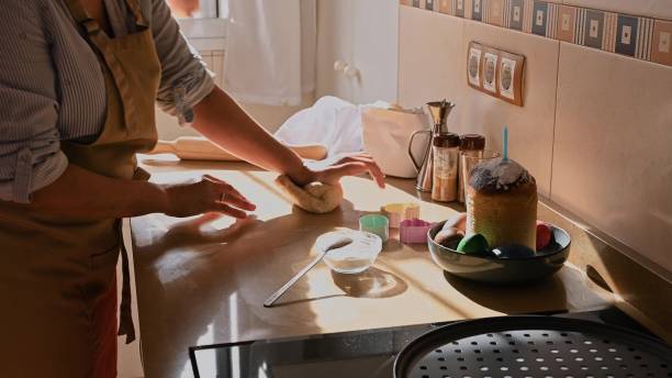 istock Woman Baking Easter Cookies in a Sunny Kitchen 2193751748