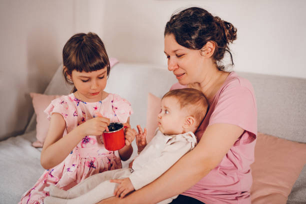 istock Mom enjoy with daughters. Meal time for baby. 2193756846