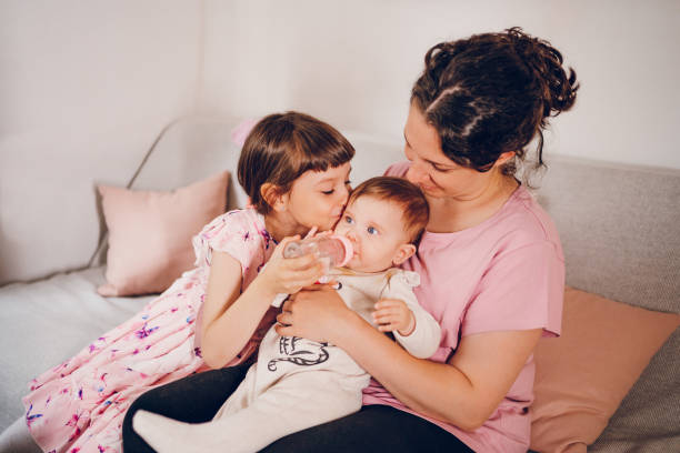 istock Mom enjoy with daughters. Meal time for baby. 2193756868