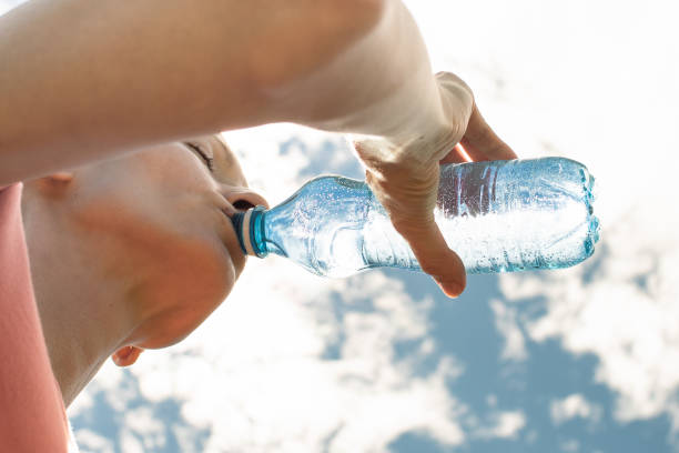 istock Female drinking water outdoors. 2193759073