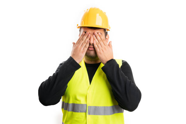 istock Builder wearing yellow helmet covering eyes as secret concept 2193759176