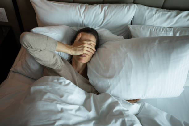 istock Woman lying down in the bed and  suffering from sleep apnea. 2193759302