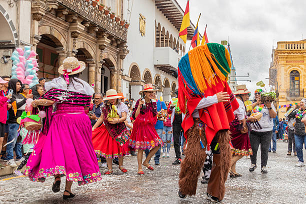 Cuenca, Ecuador - February 10, 2024: Carnival parade in the historic center of Cuenca. A group of folk dancers entertain themselves by traditionally throwing foam at each other and the audience