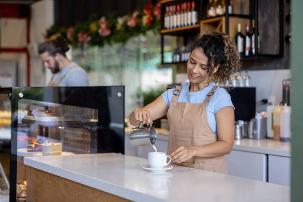 istock Barista pouring milk in a coffee at a cafe 2193767327