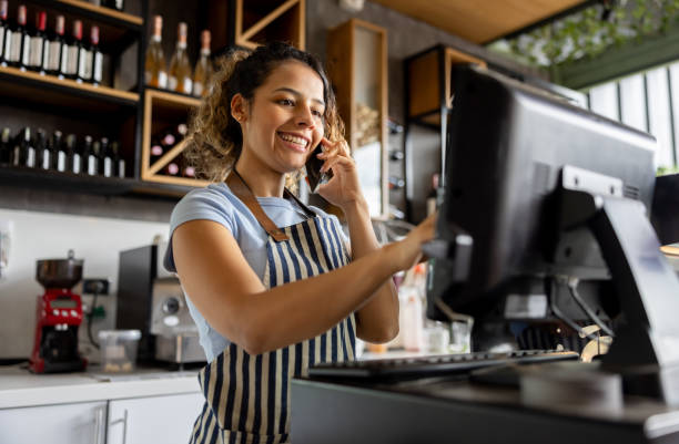istock Waitress at a cafe talking on the phone taking a delivery order 2193767329