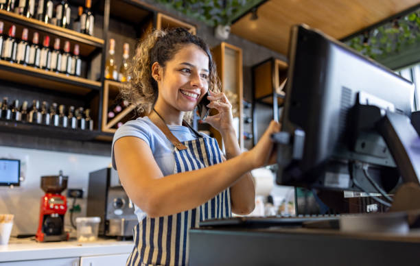 istock Waitress taking a reservation at a restaurant while talking on the phone 2193767353