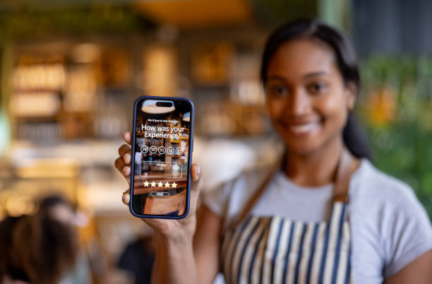 istock Waitress at a restaurant displaying an app to rate your experience 2193767395