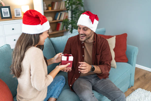istock Wife surprising husband with Christmas present 2193771967