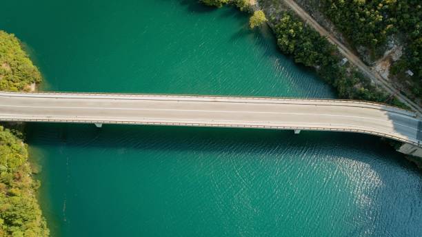 istock Aerial view of bridge over turquoise waters and greenery. 2193772207