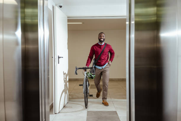istock Man enters elevator with bicycle on his commute in a modern building 2193776229