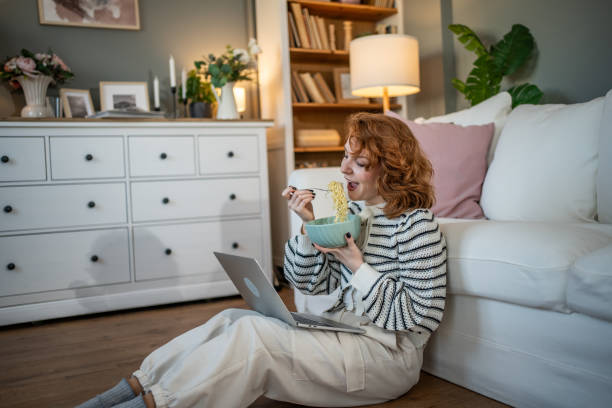 istock Breakfast with multitasking - Virtual socializing and a favorite meal 2193776794