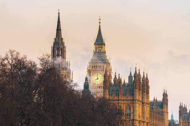 Elizabeth tower and victoria tower emerging from fog in london