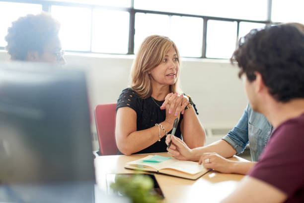 istock Unposed group of creative business people in an open concept office brainstorming their next project. 2193778198