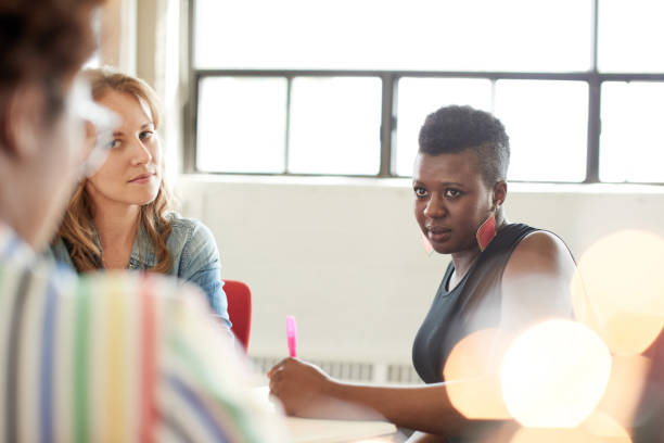istock Unposed group of creative business people in an open concept office brainstorming their next project. 2193778210