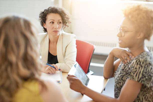 istock Unposed group of creative business people in an open concept office brainstorming their next project. 2193778212