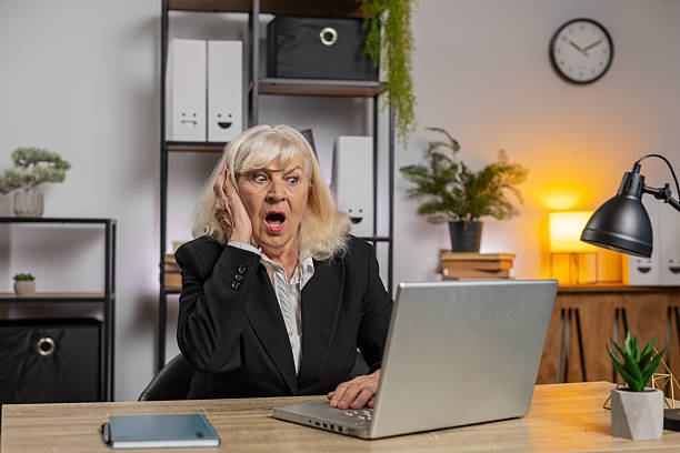istock Elderly employer freelancer using laptop working at home office having nervous breakdown at work 2193778388