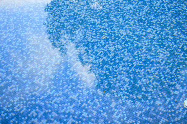 Swimming pool water surface and ripple wave with blue mosaic tiles