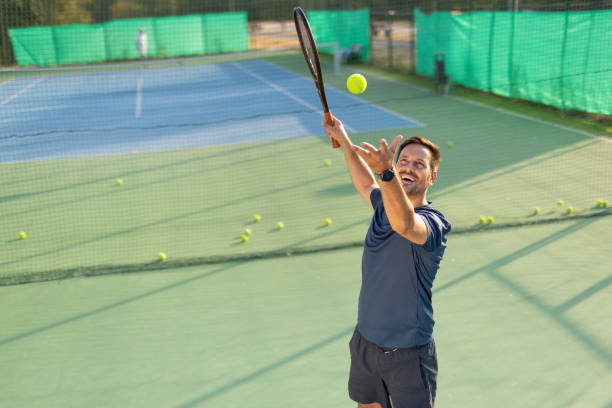 istock Tennis player throws ball preparing for a powerful serve shot 2193778683