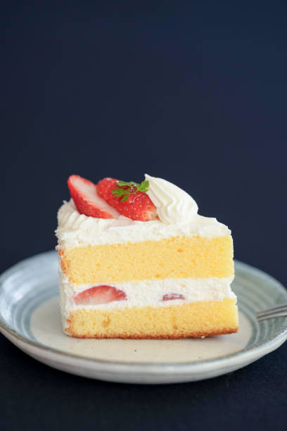 Japanese shortcake with strawberries on top is placed on a black cloth