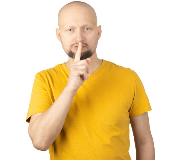 istock Serious Man in Yellow T-Shirt Making Silence Gesture with Finger 2193786015