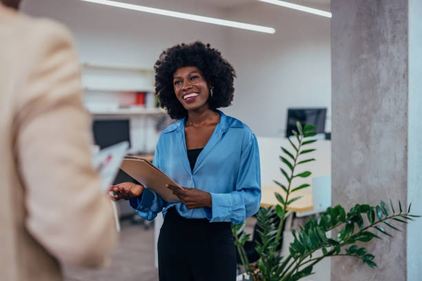 istock Confident Professional Woman Holding Clipboard in Modern Office Environment 2193787535