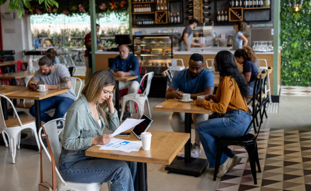 Wide shot of coffee shop with Latin American people working and talking - lifestyle concepts